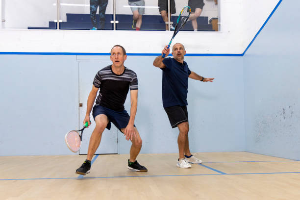 istock Two Male Squash Players Competing with Spectators Watching 2173390161