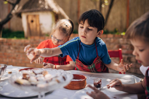 istock Children enjoying outdoor baking activity together. 2173392311
