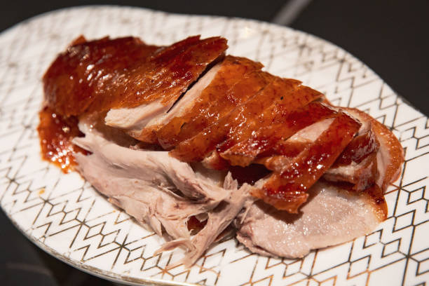 istock Authentic Chinese Peking duck served on a patterned plate showcasing succulent slices and crispy skin 2173393951