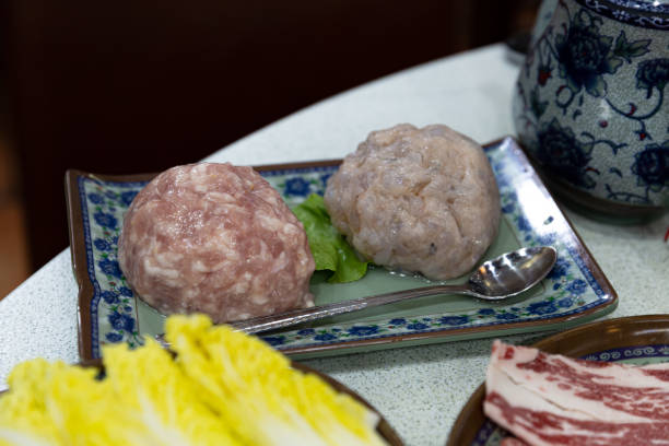 istock Assorted raw pork beef meatballs along with shrimp and fish paste served for a traditional hotpot meal 2173394262