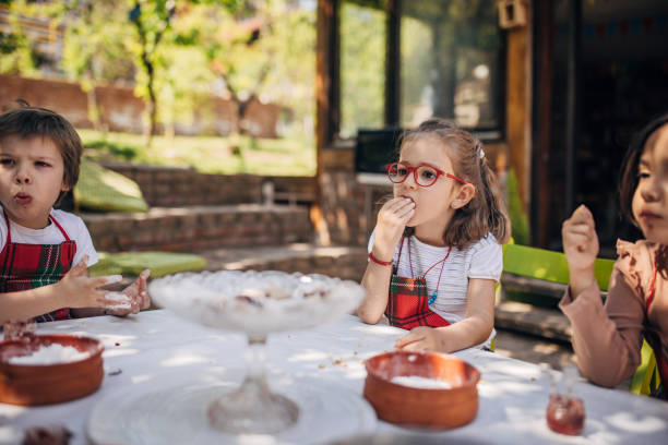 istock Children experimenting with baking in sunny backyard. 2173394622