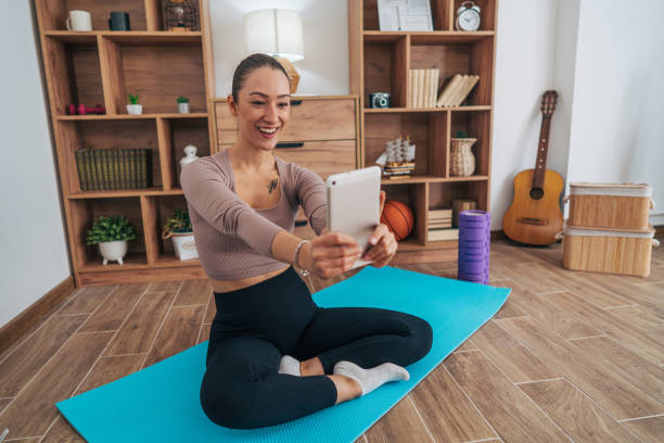 istock A young cheerful woman practicing Pilates in her living room. 2173396806