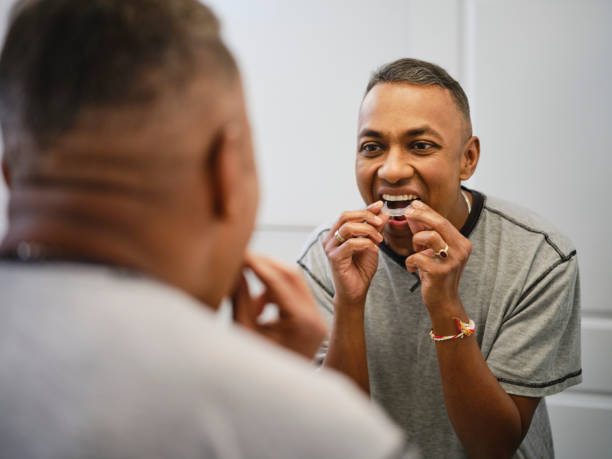 istock Mature Man Putting in Dental Aligners 2173397640