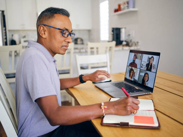 istock Mature Man on a Video Call with Co-Workers from his Home 2173398315