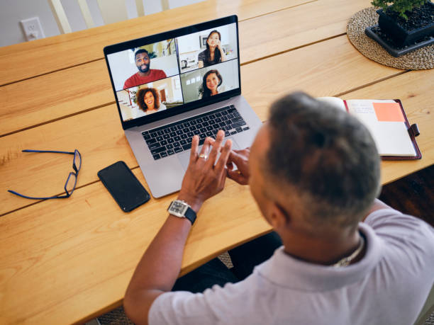 istock Mature Man on a Video Call with Co-Workers from his Home 2173398664