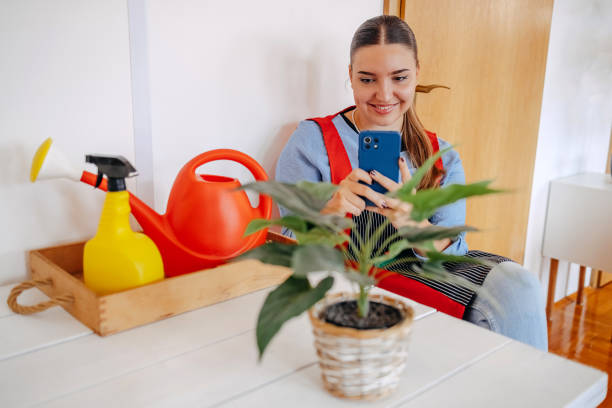 istock Young woman actively using mobile phone while sitting at home 2173398774