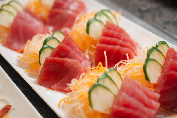 Japanese sushi with sliced tuna, neatly arranged on a white plate during buffet time.