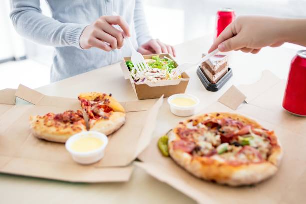 istock Colleagues eating lunch together at the office 2173405856