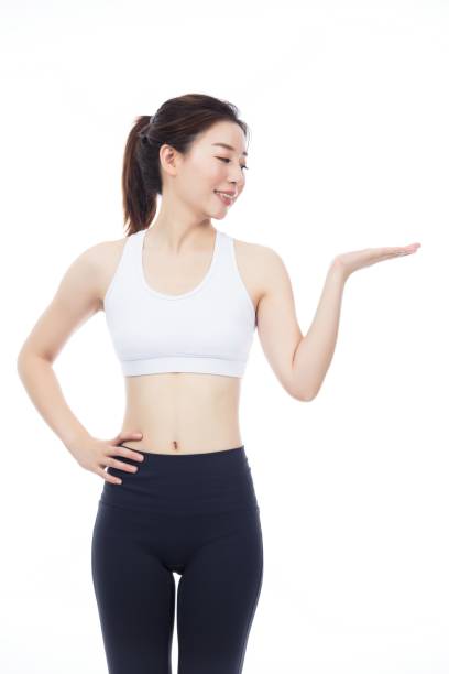 istock Cheerful Asian sportswoman presenting with hand 2173406388
