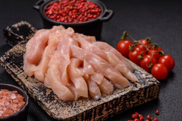 istock Raw chicken fillet cut into strips with spices and herbs 2173406569