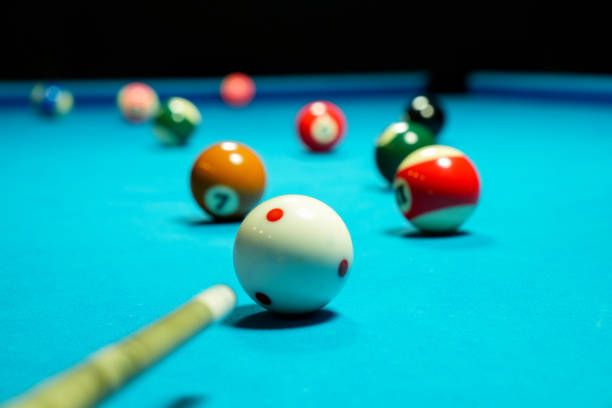 istock Billiard balls on blue table with billiard cue. Snooker, pool game 2173406669