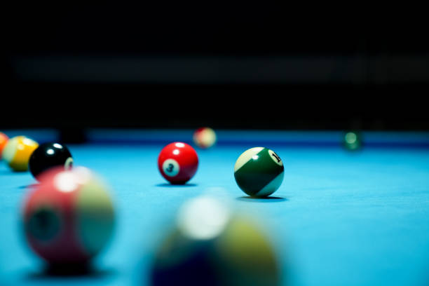 istock Billiard balls on blue table with billiard cue. Snooker, pool game 2173406677