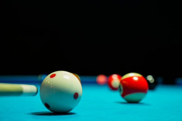 Minimal high angle view of billiard balls in triangle on green canvas table shot with flash copy space