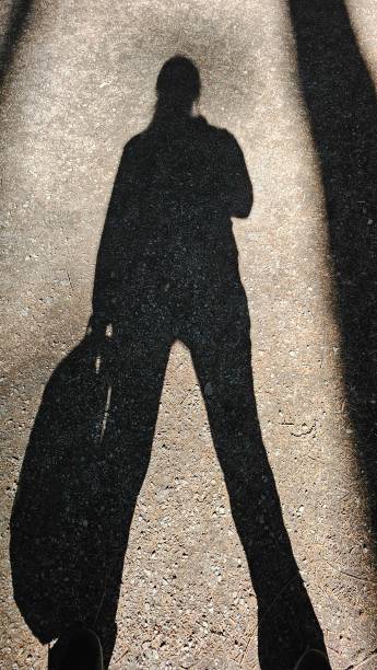 istock Determination. Shadow of a person with a backpack on the path 2173409495