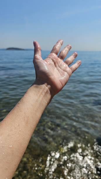 istock Hand extended forward to the sea 2173409499