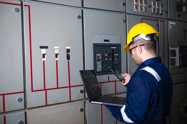 istock Electrical engineer check the operation of the main electrical control panels and switches, record values on tablets, electrician inspect the electrical systems in the factory. 2173409771