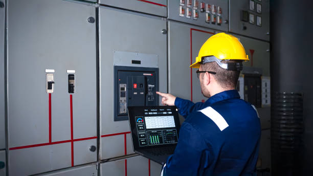 istock Electrical engineer check the operation of the main electrical control panels and switches, record values on tablets, electrician inspect the electrical systems in the factory. 2173409916