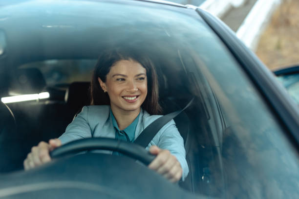 istock Beautiful woman smiling while confidently driving a car 2173410534