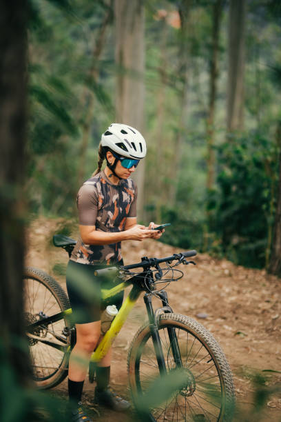 istock Woman on her bike using cell phone 2173411254