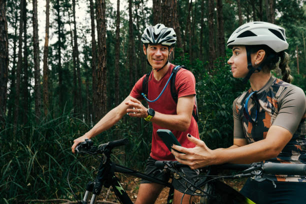 istock Man and woman cycling together and navigating on maps 2173411406