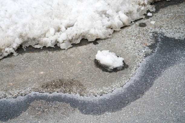 snow and ice melting on the street in spring