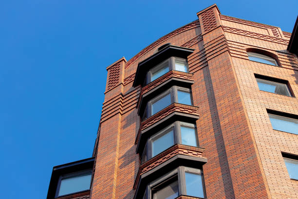 loft brick skyscraper modern building old school architecture style design external outdoor exterior facade foreshortening from below with empty blue sky background