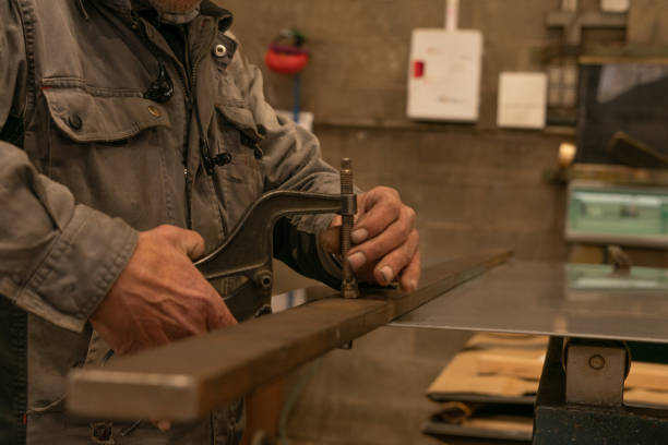 istock Close-up of a worker using a metal clamp in a workshop 2173427062