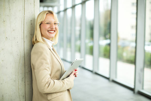 Young smiled businesswoman working in corridor