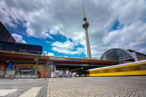 Berlin, Germany - June 23, 2024: Alexanderplatz train station. Tv tower on the background. Sunny day, medium cloudy sky.