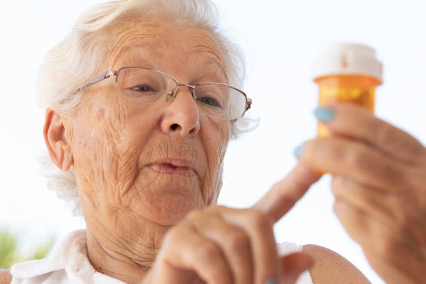 istock Senior Woman Reading the Label on a Pill Bottle 2173430849