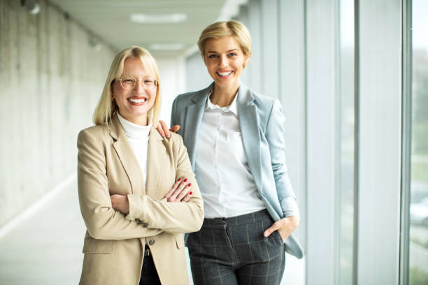 istock Happy businesswomen standing inside modern lobby 2173431039