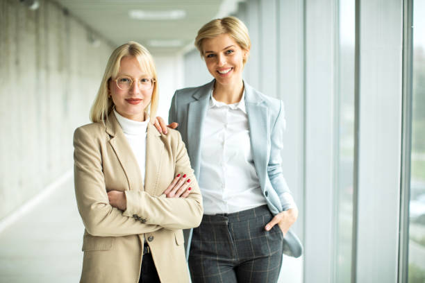 istock Happy businesswomen standing inside modern lobby 2173431048