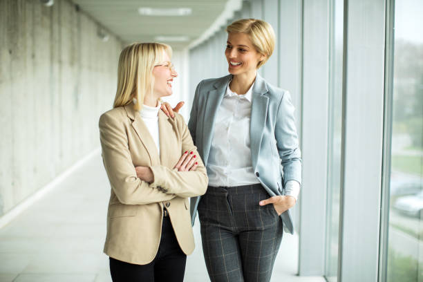 istock Happy businesswomen standing inside modern lobby 2173431098