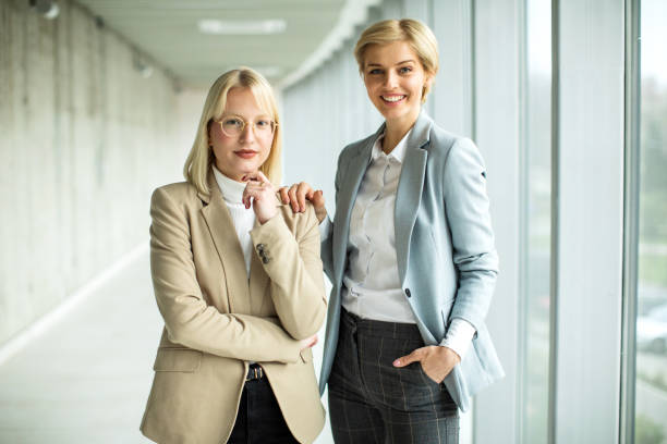 istock Happy businesswomen standing inside modern lobby 2173431104