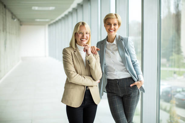 istock Happy businesswomen standing inside modern lobby 2173431110