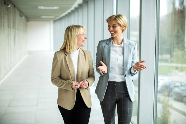 istock Happy businesswomen standing inside modern lobby 2173431133