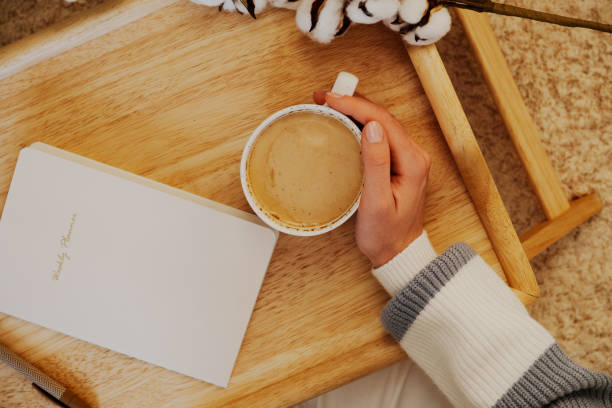 istock Hand holding a coffee cup over a wooden tray. Coffee break time concept 2173435251