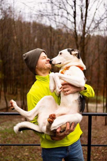 istock A Young Man holding his dog. Cherished Moments 2173441932