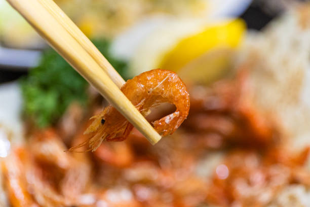 istock Japanese pub snacks - small fried shrimp held in chopsticks 2173450414