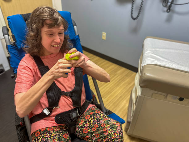 Autistic young woman entertains herself with blocks while waiting on doctor