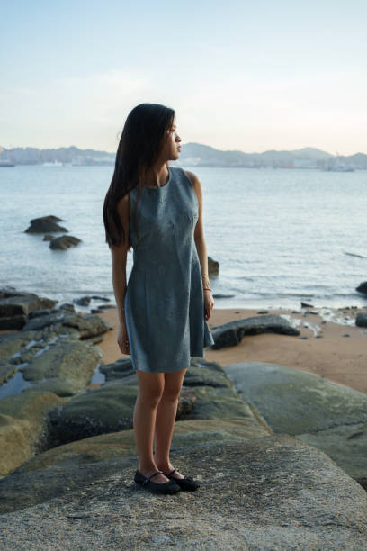 istock Asian woman standing on the beach 2173457117