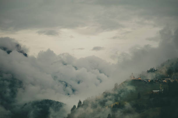 Misty clouds over mountains in summer, Dolomites