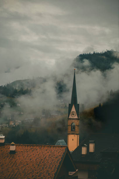 istock Church and misty clouds over mountains 2173469629