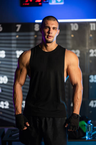 istock Young man resting in gym locker room 2173470617