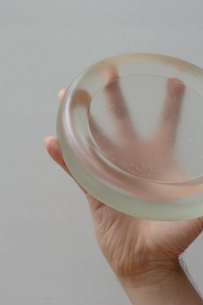 istock Hand holding transparent circular object with fingers 2173471515