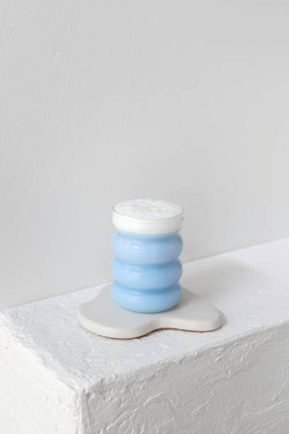 istock Foamy blue drink in a bubble glass on a white base 2173471534