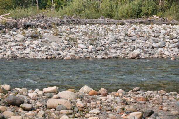 Adıyaman, Turkey - July 15, 2021: Turkish people fishing in cendere river (cendere çayı) near cendere bridge which is called Severan (Septimius Severus) Roman bridge in Mount Nemrut National Park, Eastern Anatolia, Turkey adıyaman.
