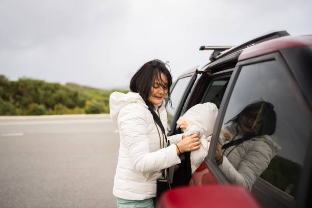 istock asian woman opening the car door and sit inside 2173478024