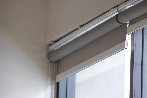 istock A window with a white curtain and a grey shade 2173478715