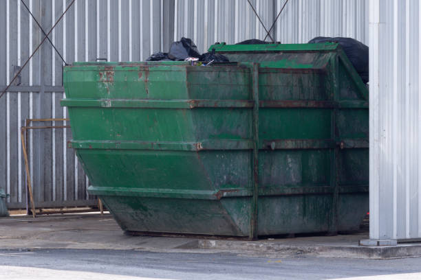 istock A large green dumpster sits in a parking lot. 2173478737